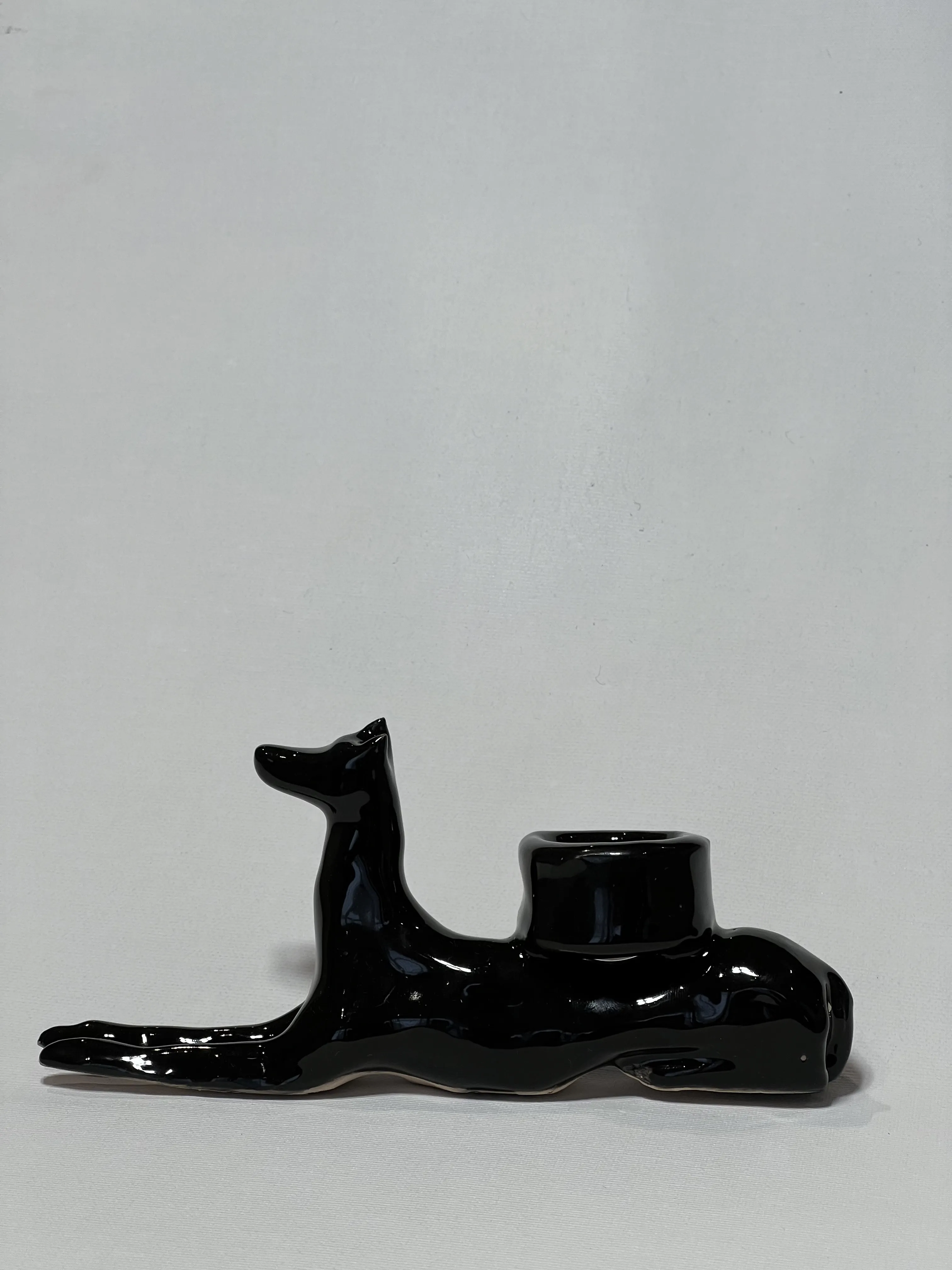 Image of “Dark dog that brings light”  by ANNA VERIKI, size: 18x6x10 cm, made of Ceramics , Sculpture medium, from Kyiv Ukraine , priced at €600 Photo 1 of 6.