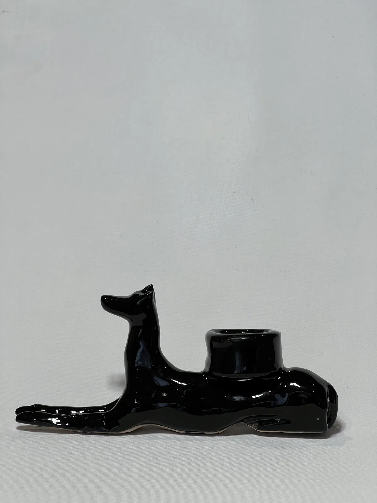 Image of “Dark dog that brings light”  by ANNA VERIKI, size: 18x6x10 cm, made of Ceramics , Sculpture medium, from Kyiv Ukraine , priced at €600 Photo 1 of 6.