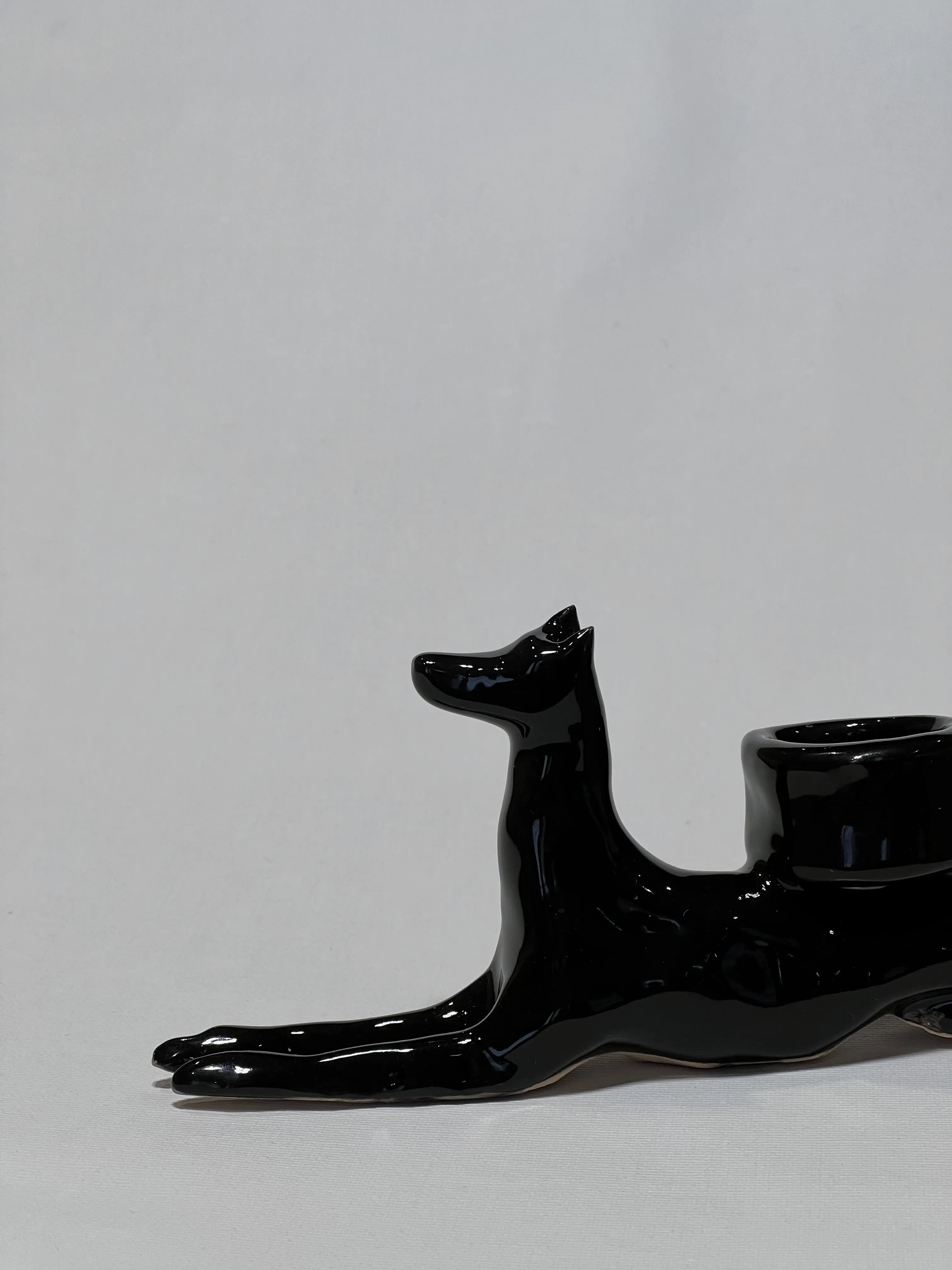 Image of “Dark dog that brings light”  by ANNA VERIKI, size: 18x6x10 cm, made of Ceramics , Sculpture medium, from Kyiv Ukraine , priced at €600 Photo 2 of 6.